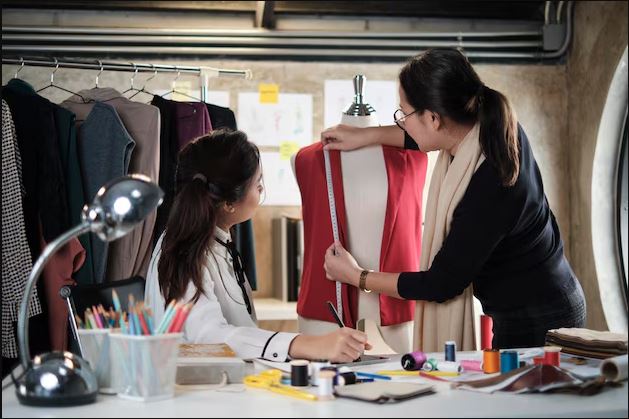 asian-female-designer-discuss-young-trainee-tailor-about-dress-design-puppet_1375095-1075